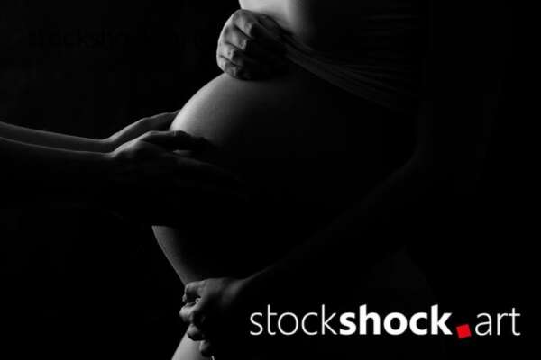 Father hands on the pregnant belly