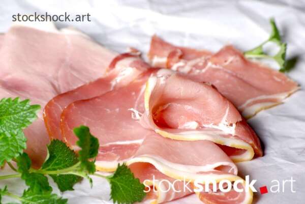 ham on a paper background with a green branch