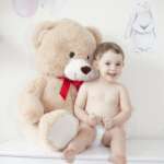 Happy girl with teddy bear against pastel background – stock