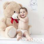 Happy girl with teddy bear against pastel background – stock