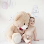 Happy girl with teddy bear against pastel background – stock