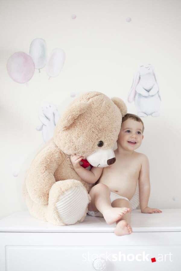Happy girl with teddy bear against pastel background – stock