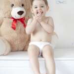 Happy girl with teddy bear against pastel background – stock