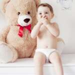 Happy girl with teddy bear against pastel background – stock