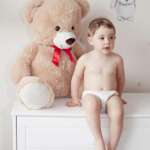 Happy girl with teddy bear against pastel background – stock