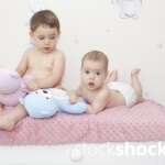 Two little girls with mascots on a pastel background