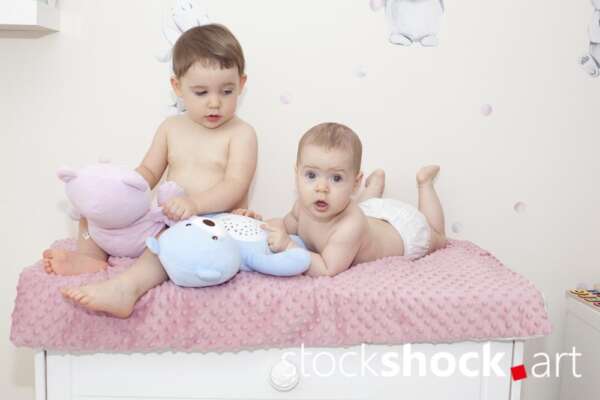 Two little girls with mascots on a pastel background