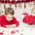 Two little girls play with Christmas decorations