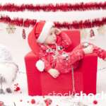 A child in a Santa Claus costume in an armchair. Christmas holidays - stockshock image