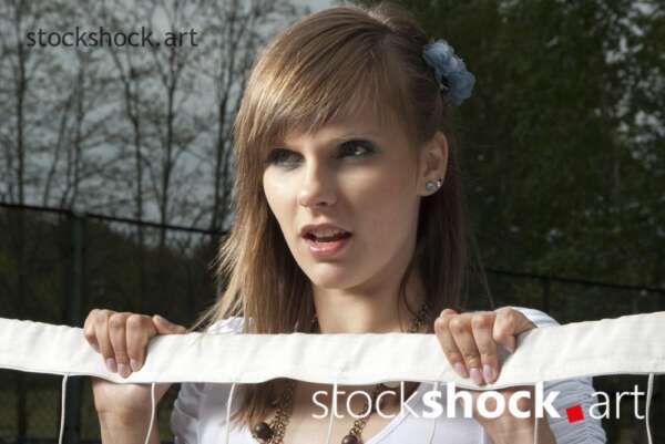 model in front of a tennis net