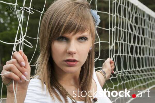 model in front of a tennis net