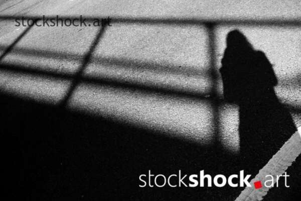 Shadow of woman on bridge, black and white, stock image