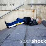 man sleeping on the stairs, homeless
