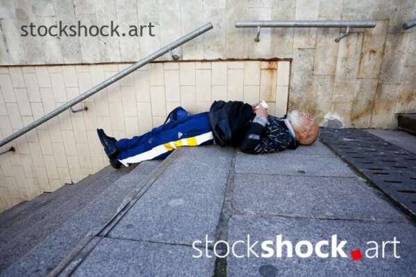 man sleeping on the stairs, homeless
