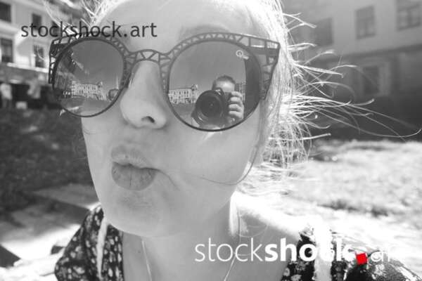 Young girl with glasses. Reflection of the image in the glasses