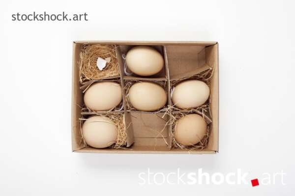 Easter. Eggs in a carton with a straw lining on a white background