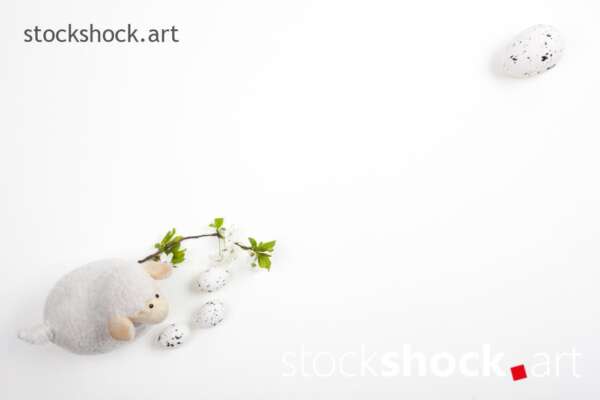 Easter lamb with eggs and a branch of blooming cherry on a white background - stock image