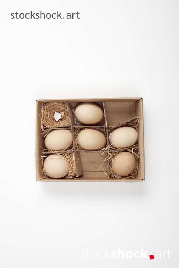 Easter. Eggs in a carton with a straw lining on a white background