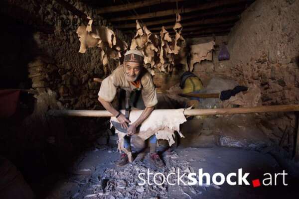 A man working on tanning leather