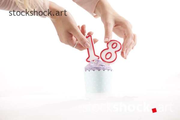 18 birthday, birthday cookie with candle - stock image