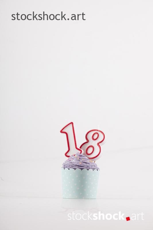 18 birthday, birthday cookie with candle - stock image
