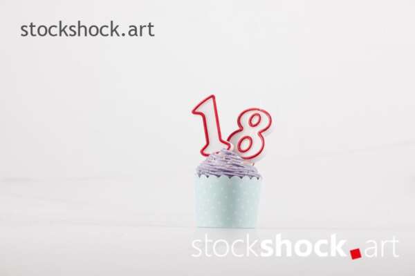 18 birthday, birthday cookie with candle - stock image