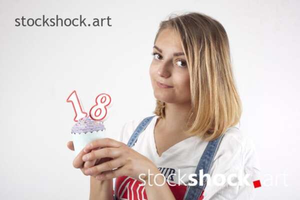18 birthday, girl with cookie and birthday candles - stock image