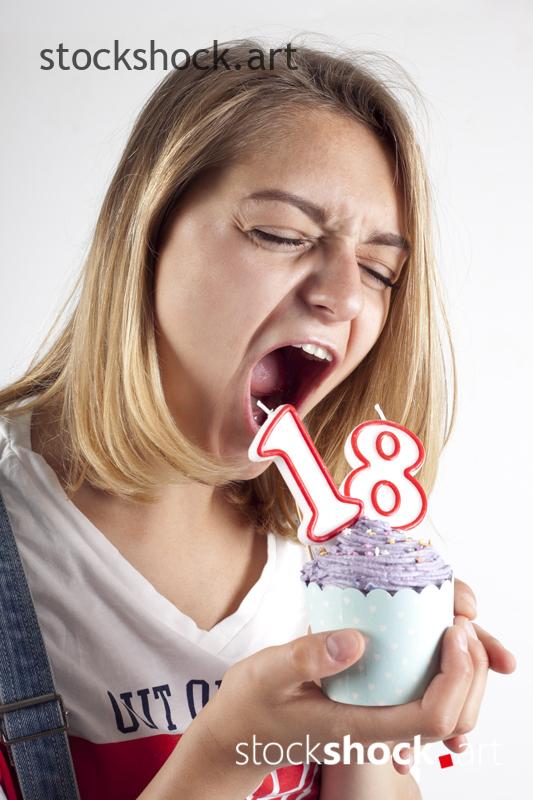 18 birthday, girl with cookie and birthday candles - stock image