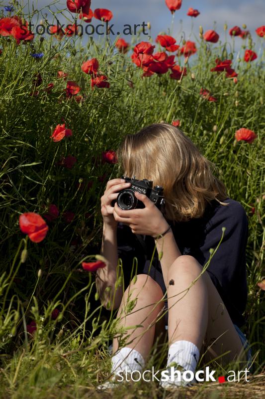 Woman with a Camera, Red poppies, stock image