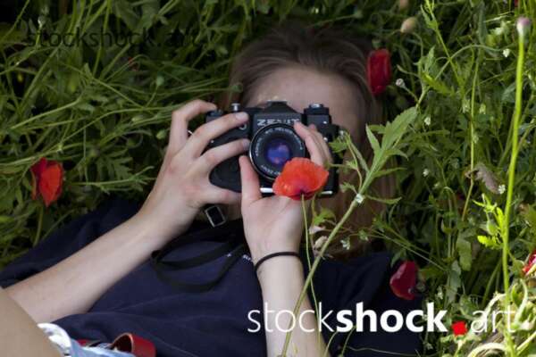Woman with a Camera, Red poppies, stock image