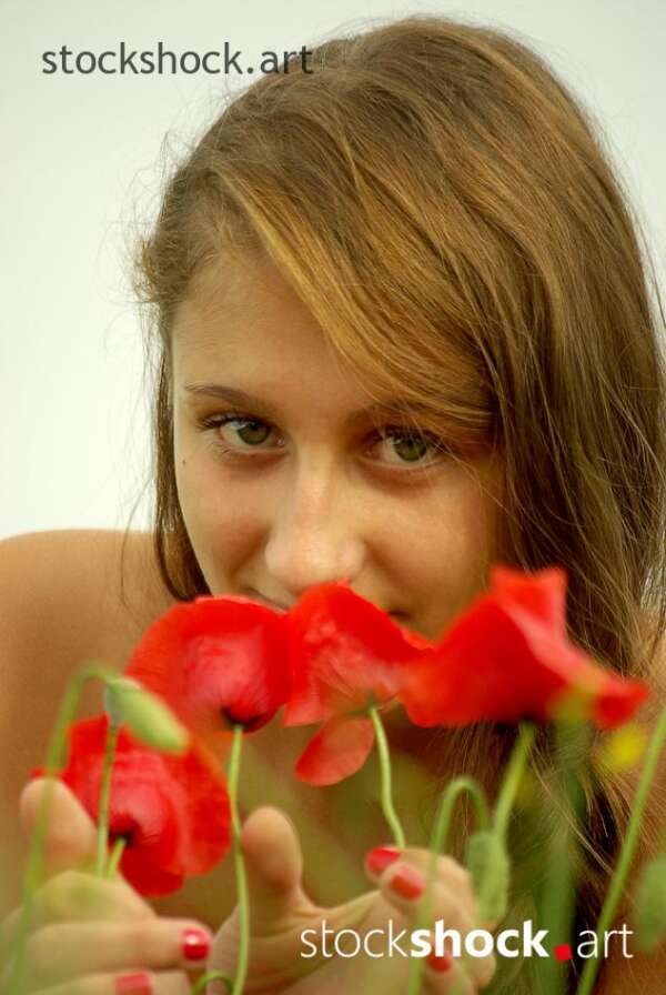 Beautiful girl in a poppy glade