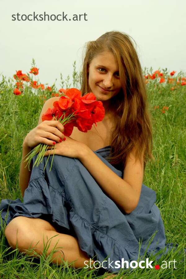 Beautiful girl in a poppy glade