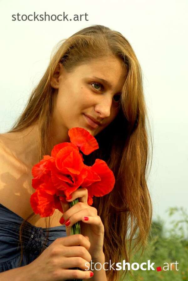 Beautiful girl in a poppy glade