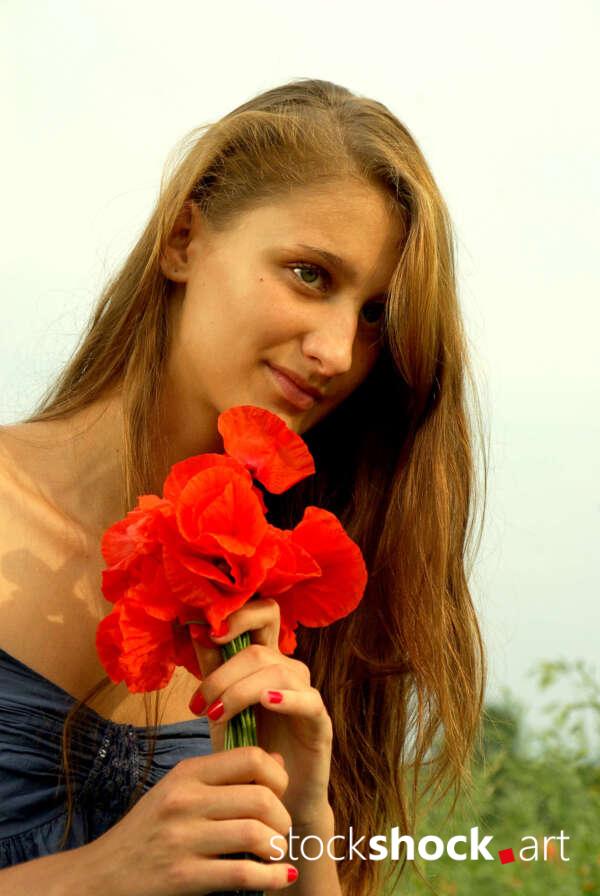 Beautiful girl in a poppy glade