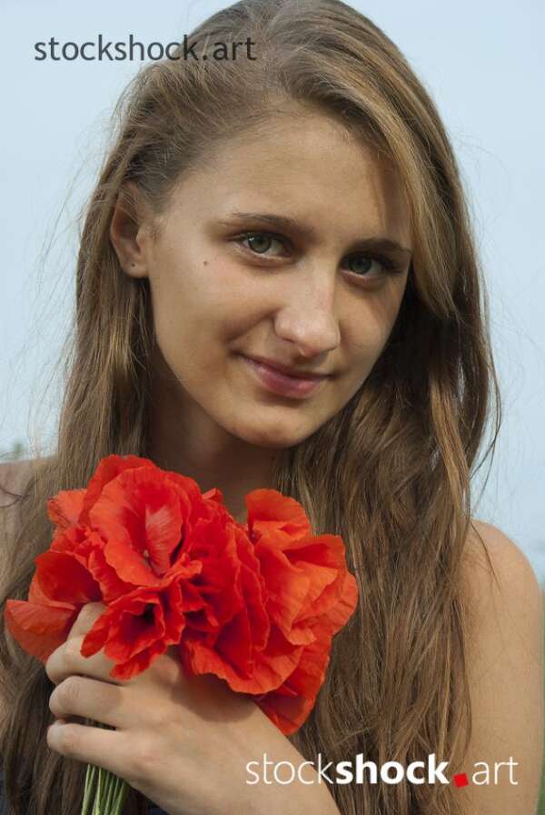 Beautiful girl in a poppy glade
