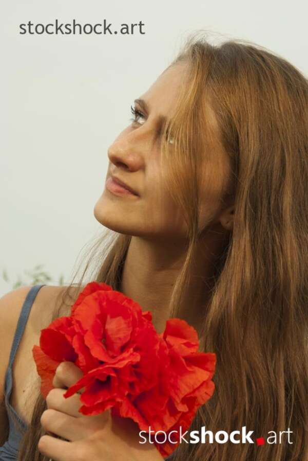 Beautiful girl in a poppy glade