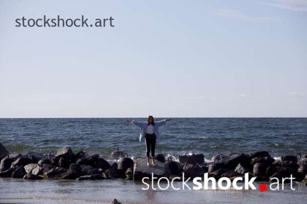 Girl on the rocks by the sea