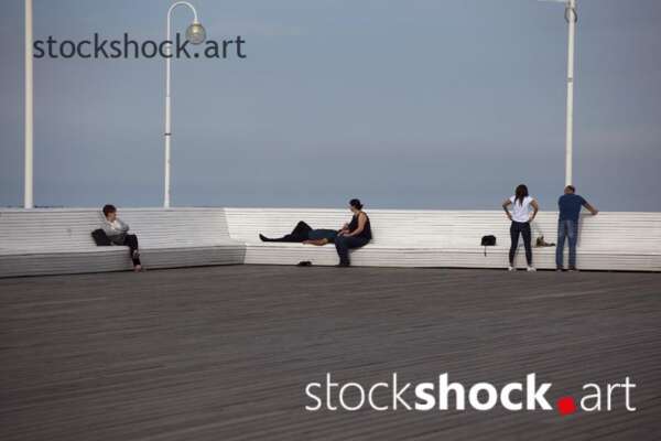 People relax on the pier