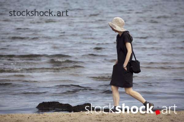 A girl walking by the sea, stock image