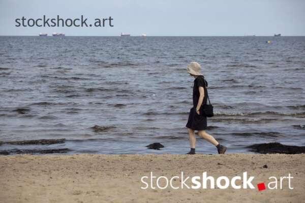A girl walking by the sea, stock image