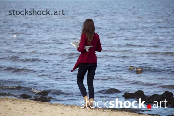 A girl walking by the sea
