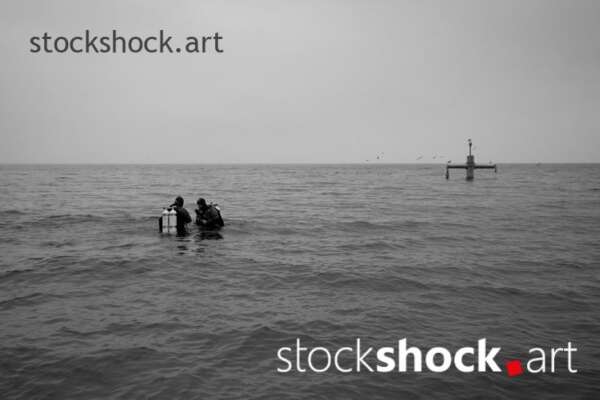 Gdańsk, Poland, Baltic Sea, two divers dive into the sea