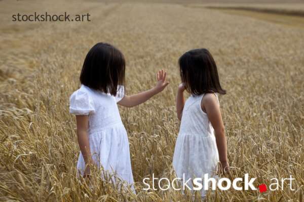 End of harvest two happy sisters playing in the field during harvest summer field - stock image, jowita niemczyk, stockshock.art