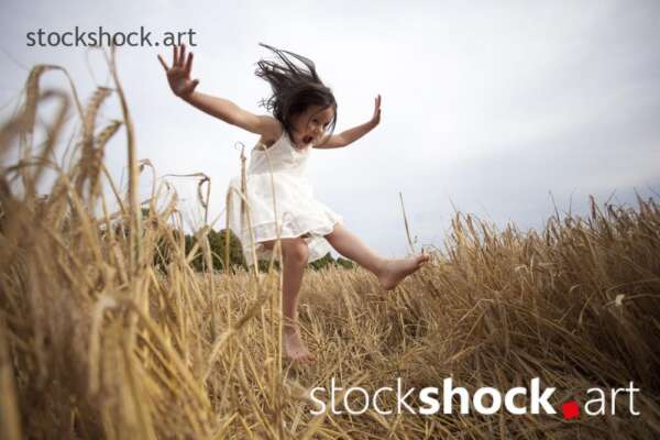 End of harvest happy girl jumping in the field during harvest summer field - stock image, jowita niemczyk, stockshock.art