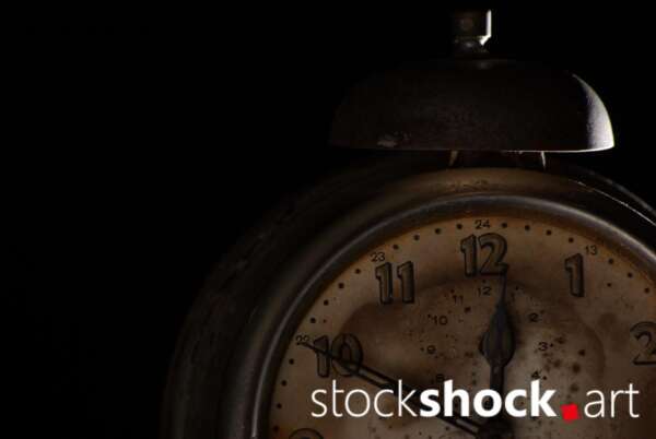 Clock, old alarm clock on black background