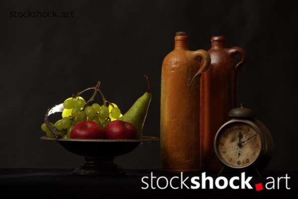 Still life with fruit and a clock symbolizing the passage of time, stock image, jowita niemczyk