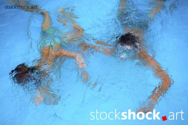 Capture a moment of joy! Two brothers enjoying a summer day, having fun in the pool. First diving, then somersaults, and finally diving.🏊‍♂️💦 The charm of childhood captured in these three shots. Check out more photos like this at stockshock.art.