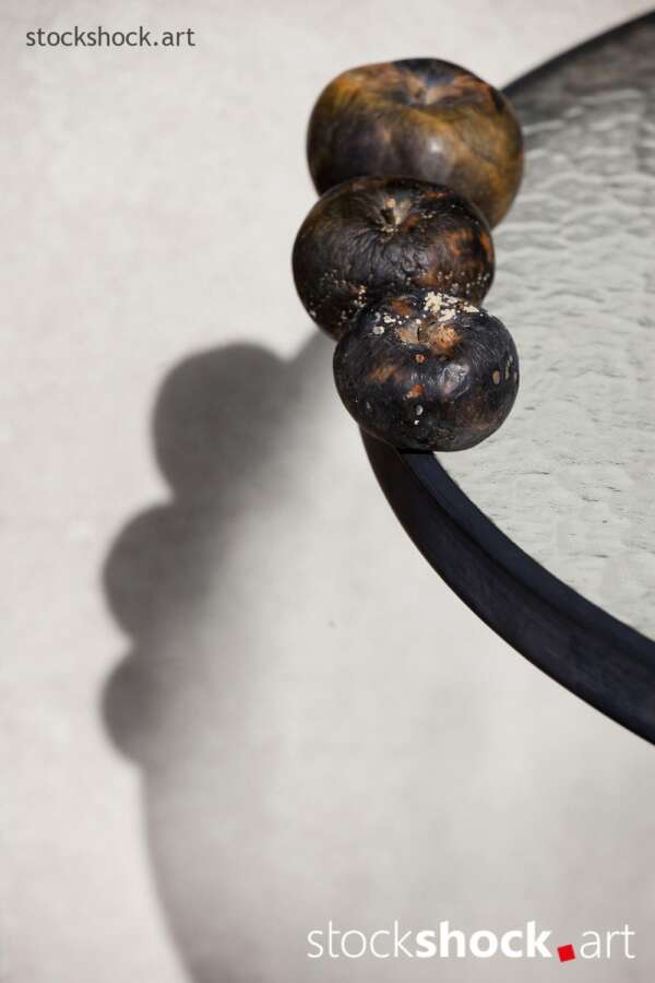 Still life, rotten apples on a glass table – stock image