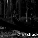 Venetian gondola tied to a wooden pole, black and white photo, stock image, stockshock.art, jowita niemczyk