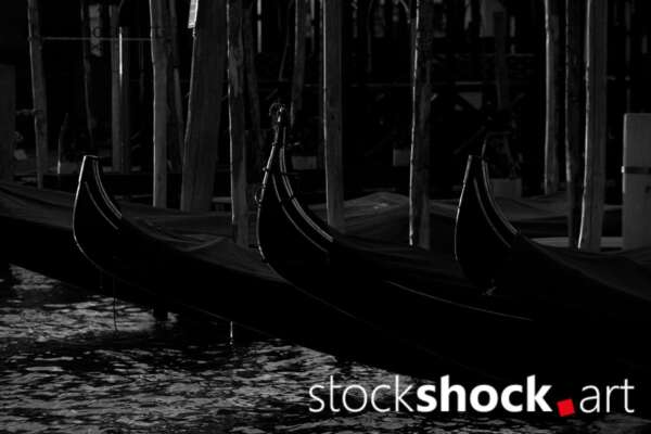 Venetian gondola tied to a wooden pole, black and white photo, stock image, stockshock.art, jowita niemczyk